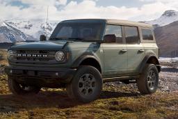 2024 Ford Bronco Big Bend in Cactus Green with snow capped mountains in the background.